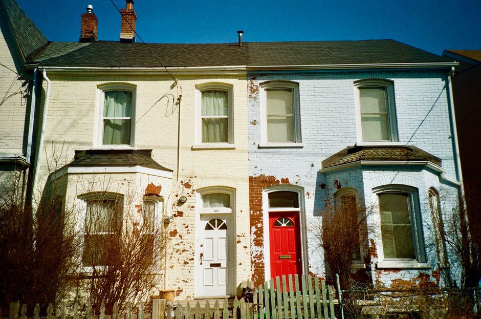 Brick house fronts with red and white painted doors.