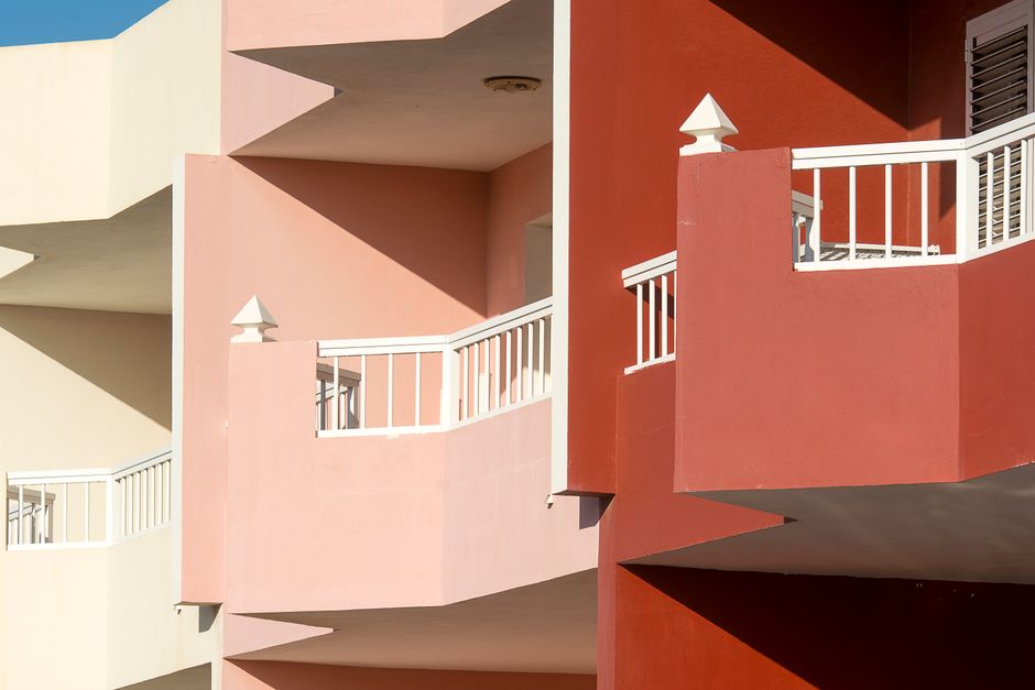 Painted walls and balconies of a building.