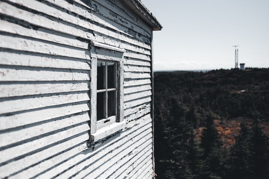Weathered wooden house with peeling paint.